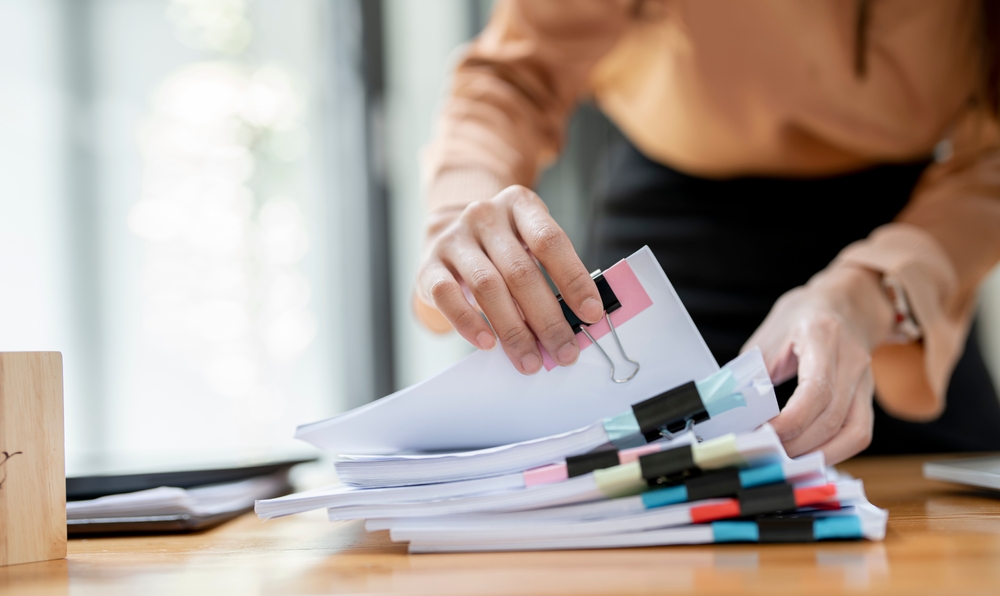 woman going through stacks of legal paperwork